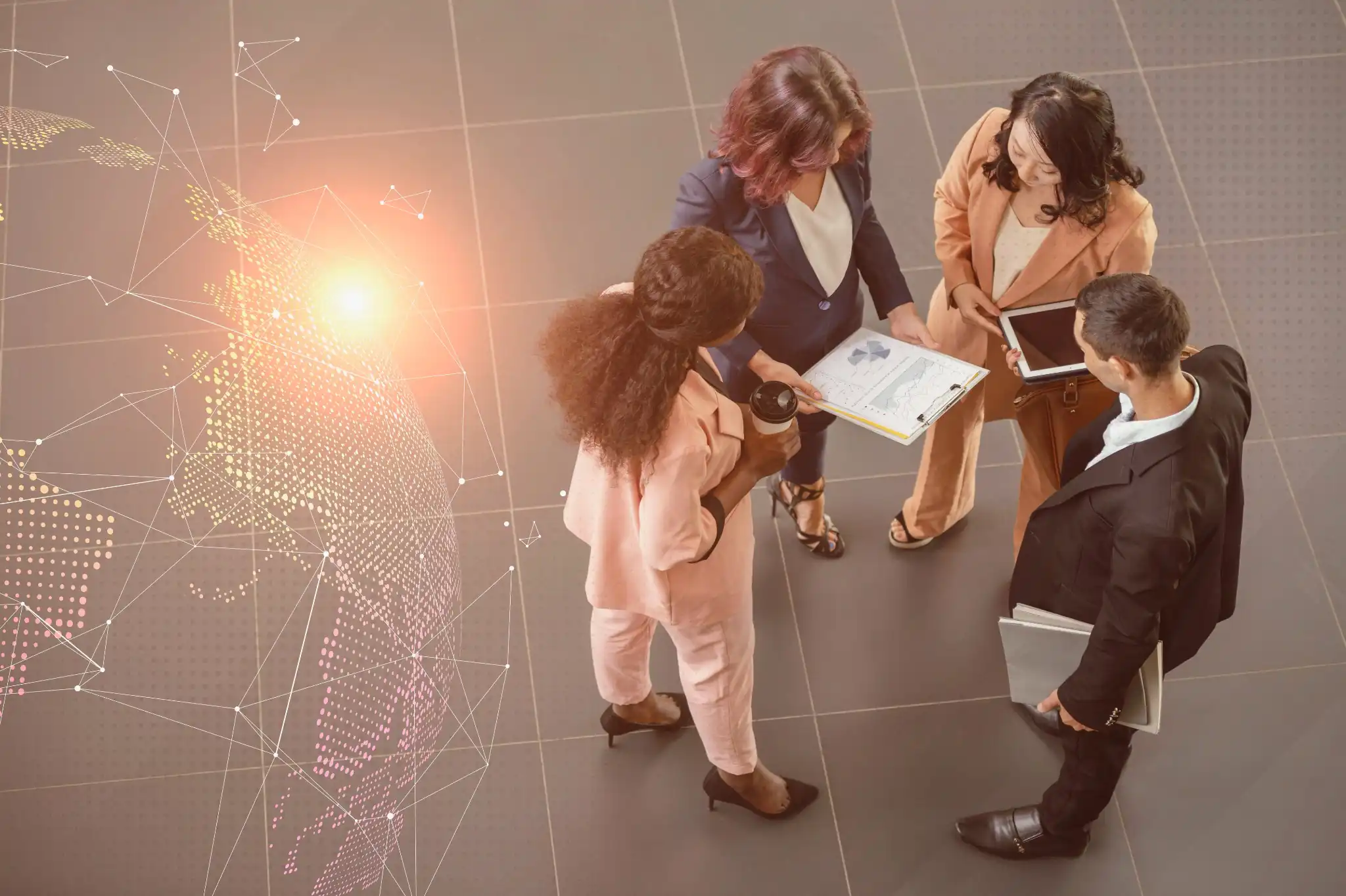 Business meeting with four people in suits, reviewing documents and using a tablet. Digital globe overlay and warm lighting set the tone.